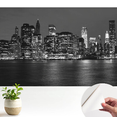 Fototapeta samoprzylepna do salonu Panorama miasta nocą z odbiciem w wodzie