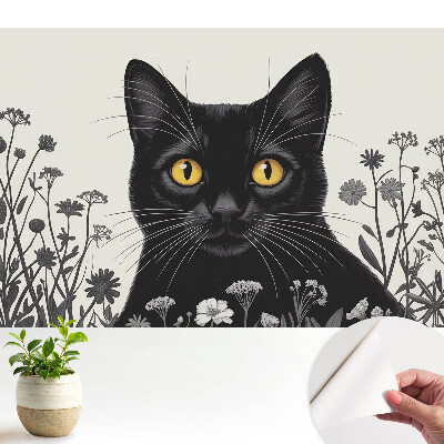 Tapeta fotograficzna samoprzylepna Czarny kot wśród kwiatów o żółtych oczach