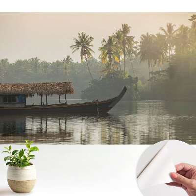 Fototapeta samoprzylepna do salonu Mistyczny pejzaż z łodzią i palmami