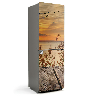 Naklejka na lodówkę Zachód słońca nad wodą