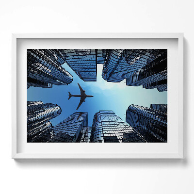 Obraz w ramie Samolot nad budynkami